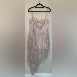 Asymmetrical dress with a cream color and floral pattern on the outside.